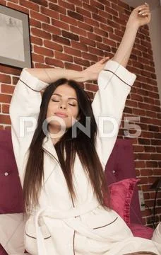 Brunette woman in white bathrobe Stock Photos