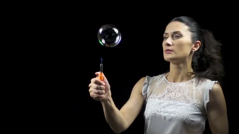 Brunette young woman and burning soap bubbles Stock Footage