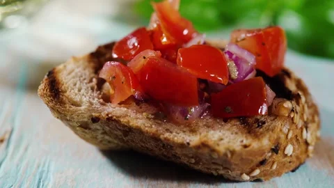 Bruschetta appetizer on slice of bread macro Stock Footage 247685823