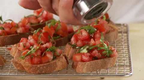 Bruschetta being sprinkled with pepper Stock Footage 24637641