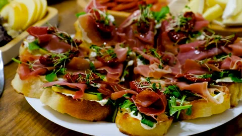 Bruschetta with jamon on a plate. Selective focus. Stock Footage 256981352