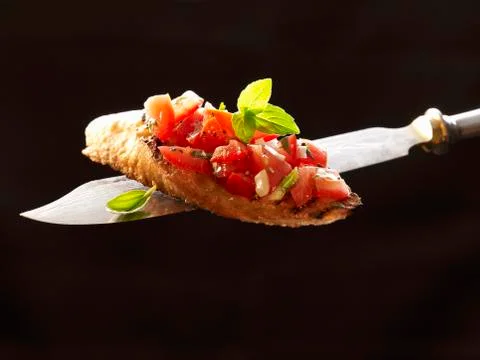 Bruschetta on a knife Stock Photos