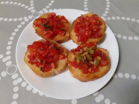 Bruschetta with tomatoes, basil and green olives and garlic Stock Photos