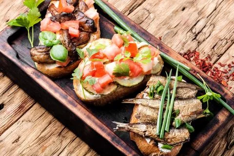 Bruschetta with various toppings. Stock Photos