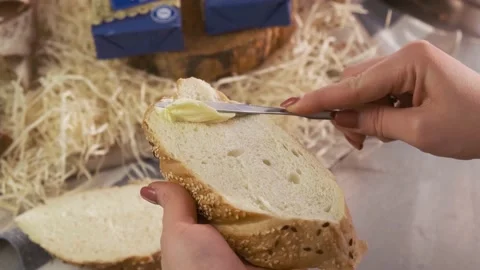Brush the bread with organic butter. Spread soft butter on a piece of bread Stock Footage 153221957