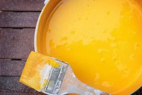 Brush on a can of yellow paint Stock Photos
