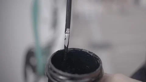 Brush dipped in black paint close up redkomodo 4k Stock Footage 253490264