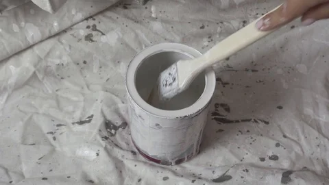 Brush dipped in a jar of white paint Stock Footage 116130106