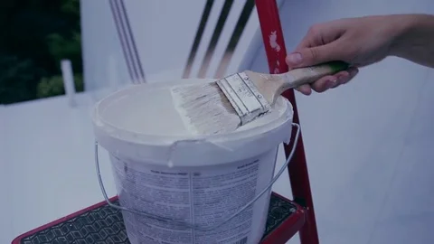 The brush is dipping into the paint cans. Stock Footage 82669623