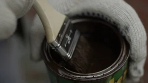 Brush dips into the paint can Stock Footage 70718862