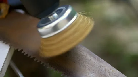 Brush on a drill polishing a rusty saw Video stock 62464597