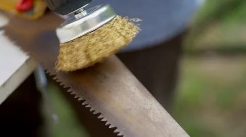 Brush on a drill polishing a rusty saw Stock Footage 62464912