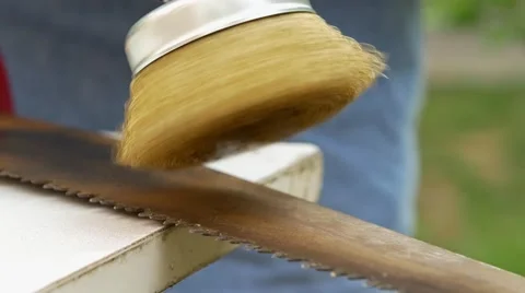 Brush on a drill polishing a rusty saw Stock Footage 62465008