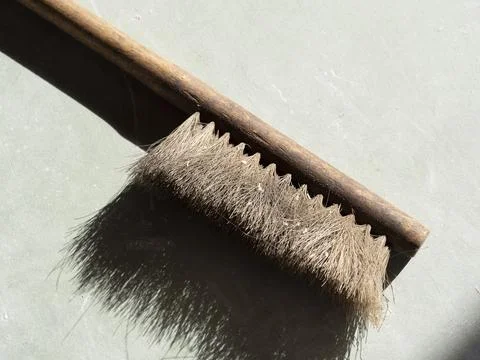 Brush for dusting on a gray background. Close-up, selective focus, hard shado Stock Photos
