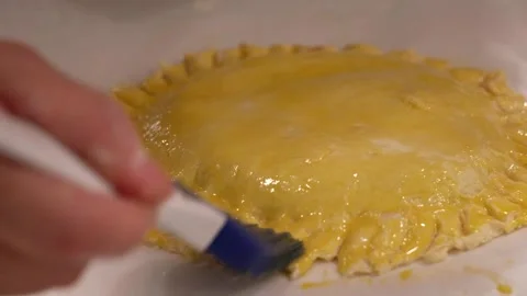 Brush egg on the cake Stock Footage 276602897