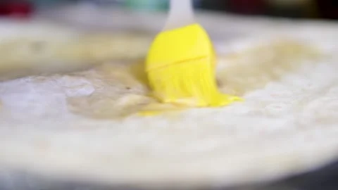 Brush with egg process of preparing doner, a young woman dressed in an apron in Stock Footage 309234148
