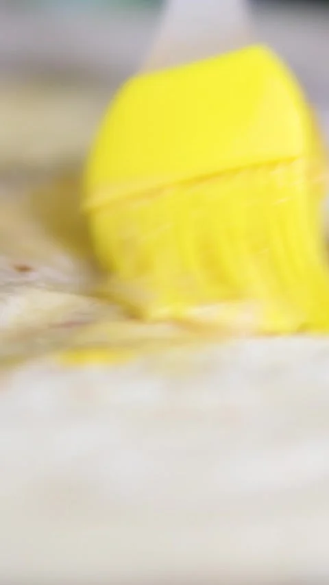 Brush with egg process of preparing doner, a young woman dressed in an apron in Stock Footage 309439439