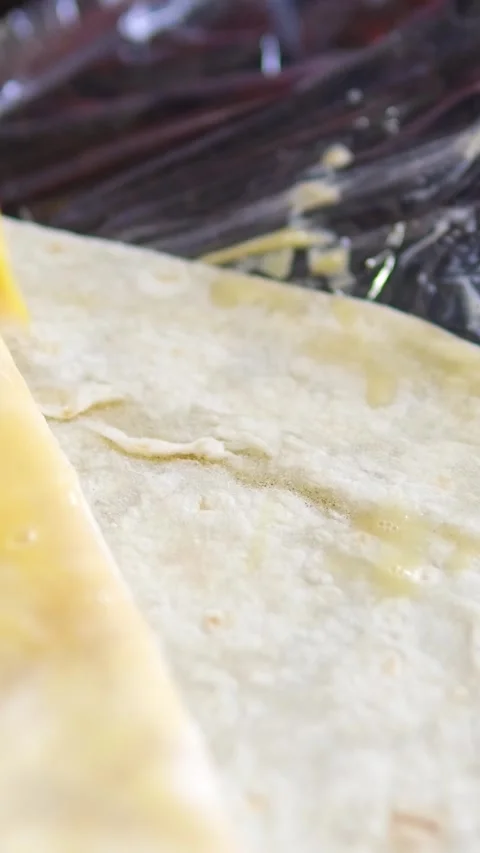 Brush with egg process of preparing doner, a young woman dressed in an apron in Stock Footage 309441044