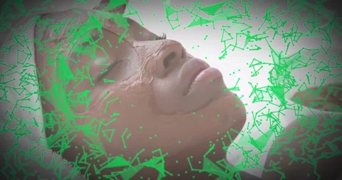 Brush entering triggers applying mask onto spa client for skincare with green Stock Footage 327902398
