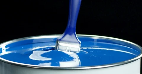 Brush falling into bright blue paint slow motion closeup Stock Footage 118464537