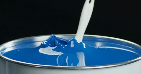 Brush falling into can with bright blue paint slow motion. Stock Footage 118527937