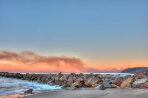 Brush fire in distance polluting the ocean air. Stock Photos