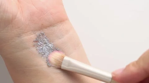 Brush gains silver gray glitter pigment on pile to be used in make-up. Arti.. Stock Footage 248534642