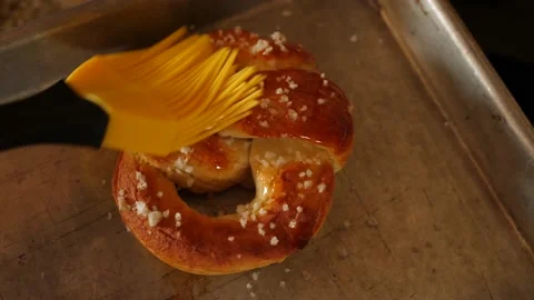 Brush greasing yolk to the pretzel Stock-Footage 145909204