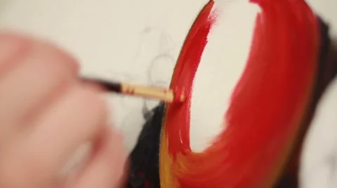Brush in hand causing an oil smears of red paint on the canvas. The artist draws Stock Footage 67163822