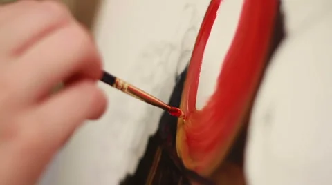Brush in hand causing an oil smears of red paint on the canvas. The artist draws Stock Footage 67163880