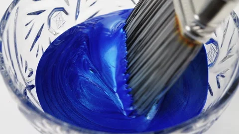 Brush inside liquid blue bright paint Video stock 255886470