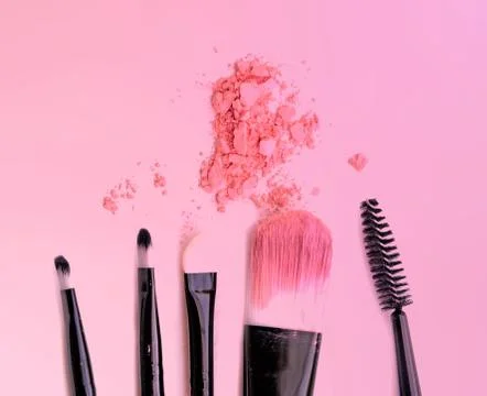 Brush make up set crushed make up power on pink background. Stock Photos