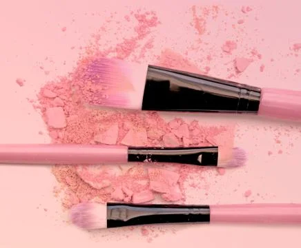 Brush make up set crushed make up power on pink background. Stock Photos