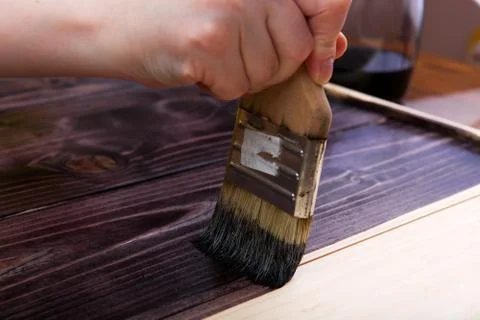 Brush with paint close-up on a light background. Hand craft. Stock Photos