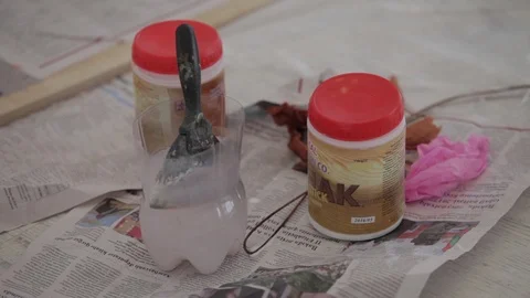 Brush, paint an old newspaper on the floor Stock Footage 86456528