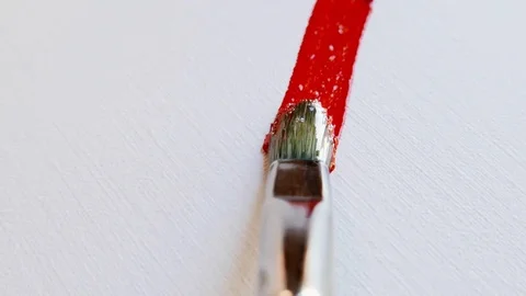 A brush paints a red stroke on a white canvas Stock Footage 80832827