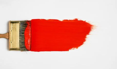 Brush with red paint lies on a white background, top view Stock Photos