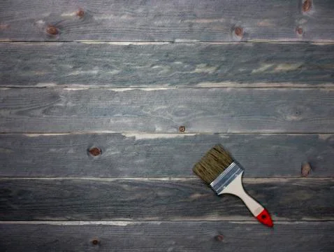 The brush rests on aged boards. Background of old boards Stock Photos