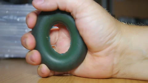 The brush squeezing a carpal expander Stock Footage 91962529