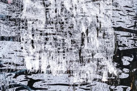Brush strokes white pattern on a black wall texture. Abstract background 写真素材