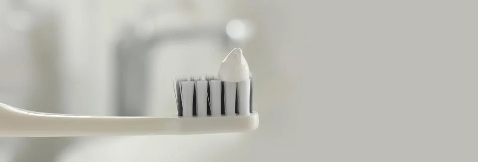Brush with toothpaste in bathroom, space for text. Banner design Stock Photos
