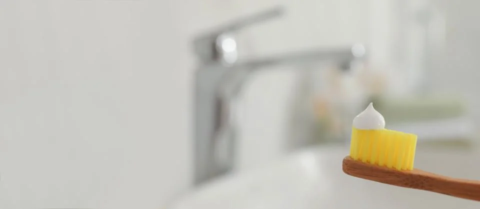 Brush with toothpaste in bathroom, space for text. Banner design Stock Photos