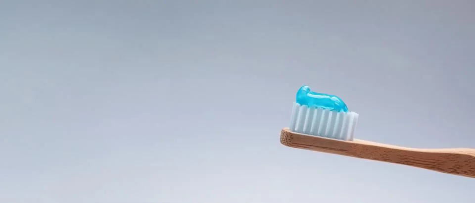 Brush with toothpaste on grey background, space for text. Banner design Stock Photos