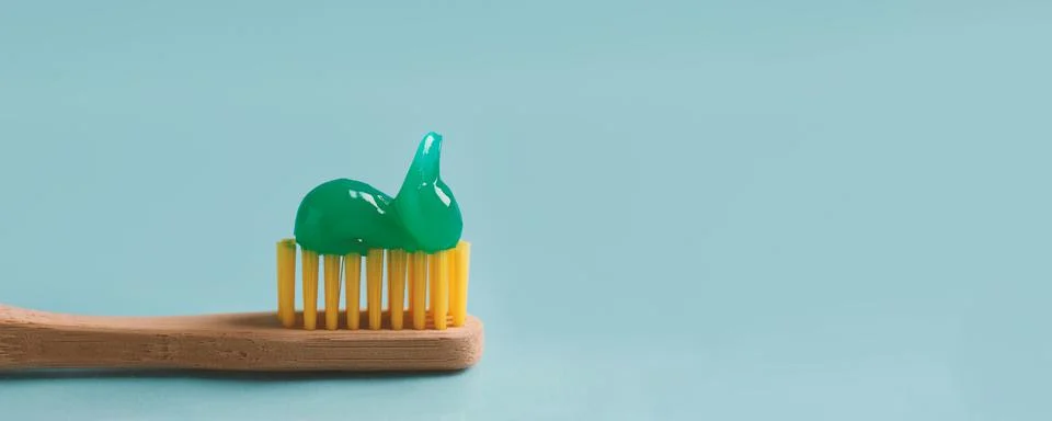 Brush with toothpaste on light blue background, space for text. Banner design Stock Photos