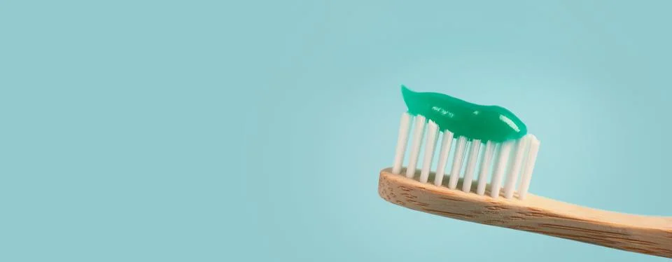 Brush with toothpaste on light blue background, space for text. Banner design Stock Photos
