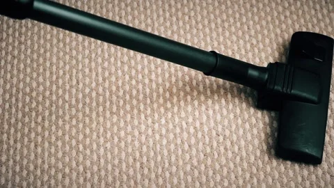 The brush for the vacuum cleaner moves over the carpet Stock Footage 85692290