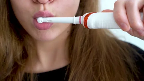 Brush your teeth with an electric toothbrush close-up Stock Footage 146076068