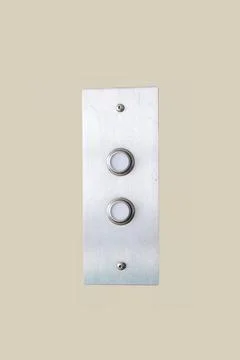 Brushed aluminum elevator call button panel on wall Stock Photos