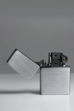 Brushed chrome lighter with windproof. vertical Stock Photos