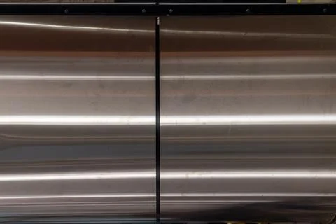 Brushed metal surface with horizontal lines and reflective steel texture Stock Photos